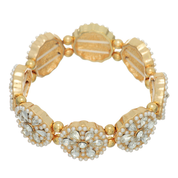 Gold tone stretch bracelet featuring rhinestone flowers with faux ivory pearl accents.