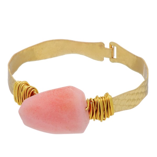 Gold tone latch bracelet with a wire wrapped pale pink stone focal. 