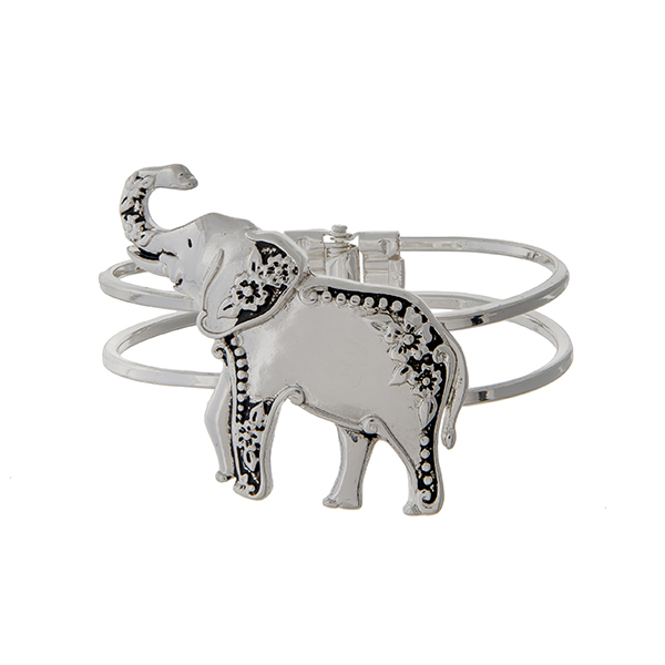 Silver tone hinged bangle bracelet with an elephant focal. 