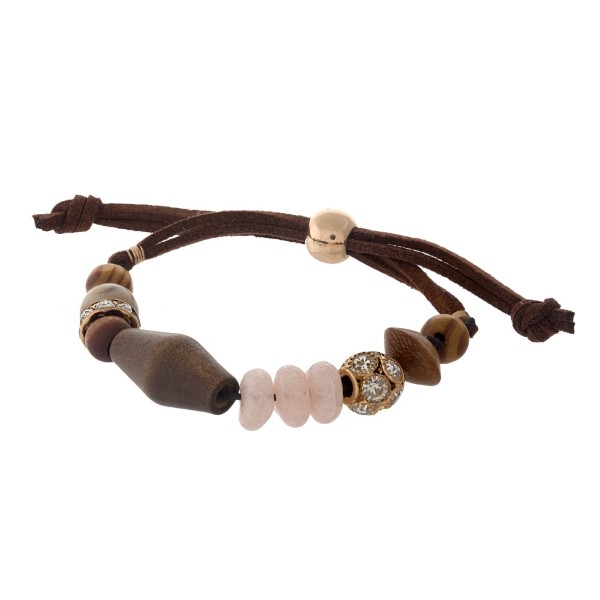 Adjustable brown cord bracelet with wooden and ivory beads. 