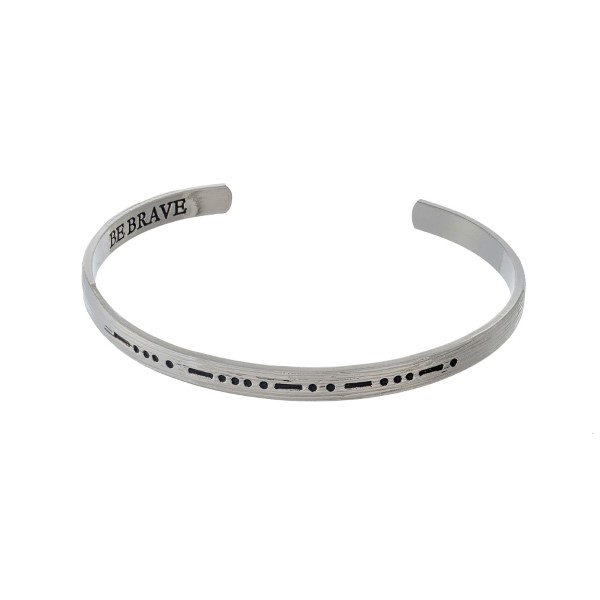 Silver tone cuff bracelet stamped on the outside with morse code and "be brave' on the inside. 