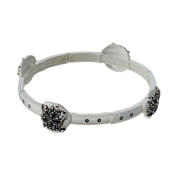 Silver tone stretch bracelet featuring sand dollar charms.  
