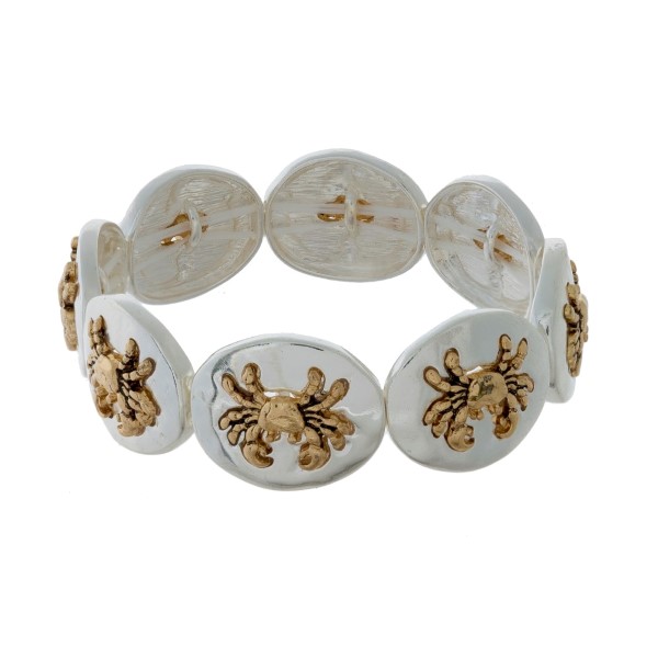 Silver tone stretch bracelet with gold tone sea life focals. 
