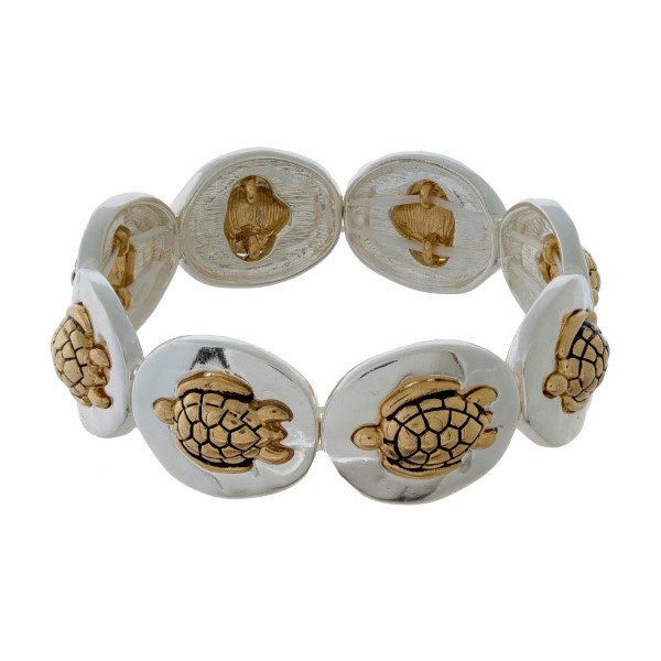 Silver tone stretch bracelet with gold tone sea life focals. 