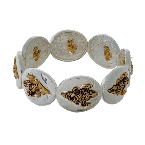 Silver tone stretch bracelet with gold tone sea life focals. 