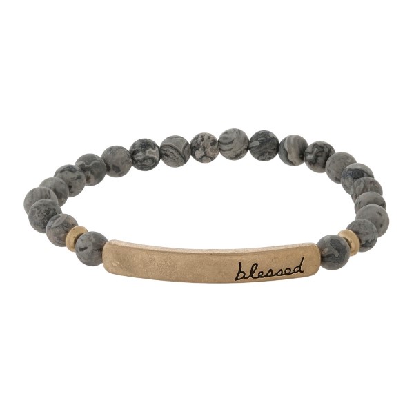 Beaded stretch bracelet with a bar focal, stamped with "blessed."