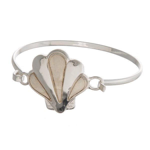 Metal, latch bracelet with a sea life focal. 