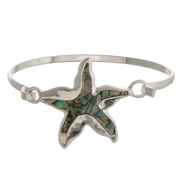 Metal, latch bracelet with a sea life focal accented with natural shell. 