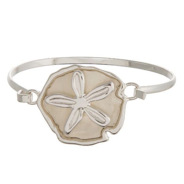 Metal, latch bracelet with a sea life focal.

