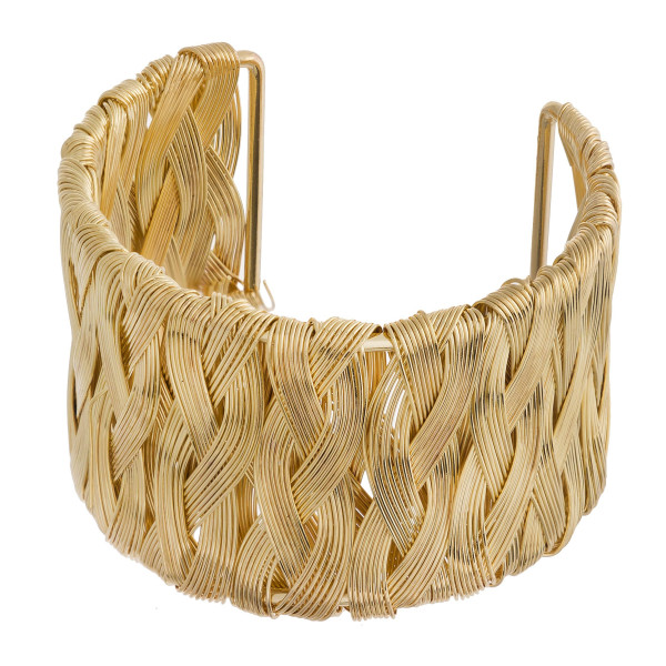 Gold cuff bracelet featuring a metal wire inspired pattern. Approximately 2.5" in diameter. Fits up to a 5" wrist.