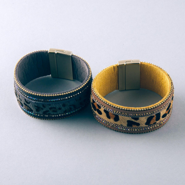 Faux fur leopard print magnetic bracelet featuring rhinestone and bead accents. Approximately 3" in diameter and 1.25" in width.