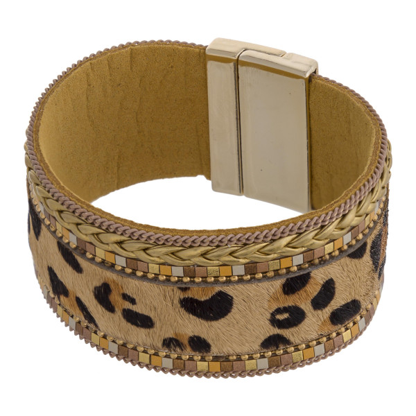 Faux fur leopard print magnetic bracelet featuring braided details. Approximately 3" in diameter and 1" in width. Fits up to a 6" wrist.