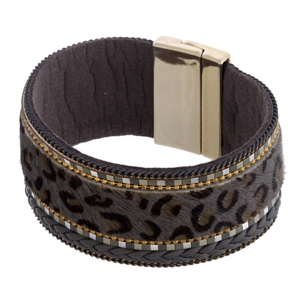 Faux fur leopard print magnetic bracelet featuring braided details. Approximately 3" in diameter and 1" in width. Fits up to a 6" wrist.
