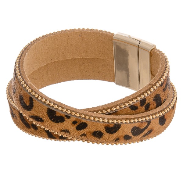 Faux leather criss-cross leopard print magnetic bracelet.

- Magnetic closure
- Approximately 3" in diameter
- Fits up to a 6" wrist