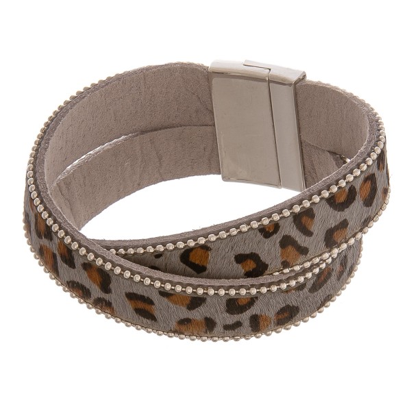 Faux leather criss-cross leopard print magnetic bracelet.

- Magnetic closure
- Approximately 3" in diameter
- Fits up to a 6" wrist