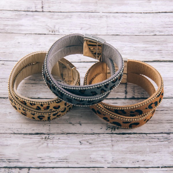 Faux leather criss-cross leopard print magnetic bracelet.

- Magnetic closure
- Approximately 3" in diameter
- Fits up to a 6" wrist