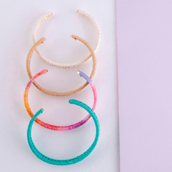 Tie Dye raffia woven cuff bracelet.

- Approximately 2.5" in diameter
- Fits up to a 5" wrist