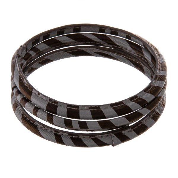 Faux leather wrapped zebra print bangle bracelet set of three.

 - Approximately 3" in diameter
- Fits up to a 6" wrist