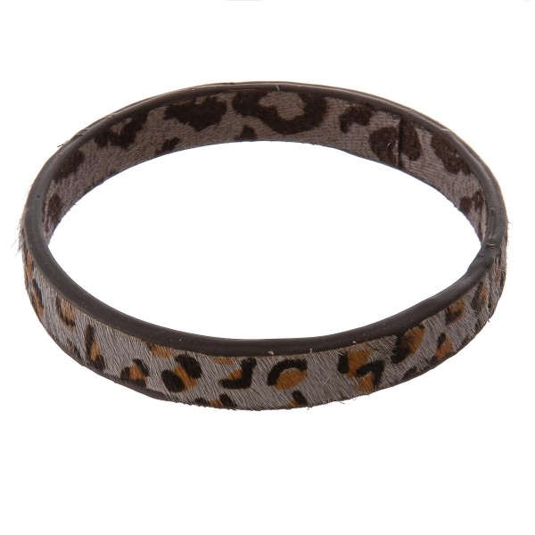Genuine leather double sided leopard print cowhide bangle bracelet.

- Approximately 3" in diameter
- Fits up to a 6" wrist