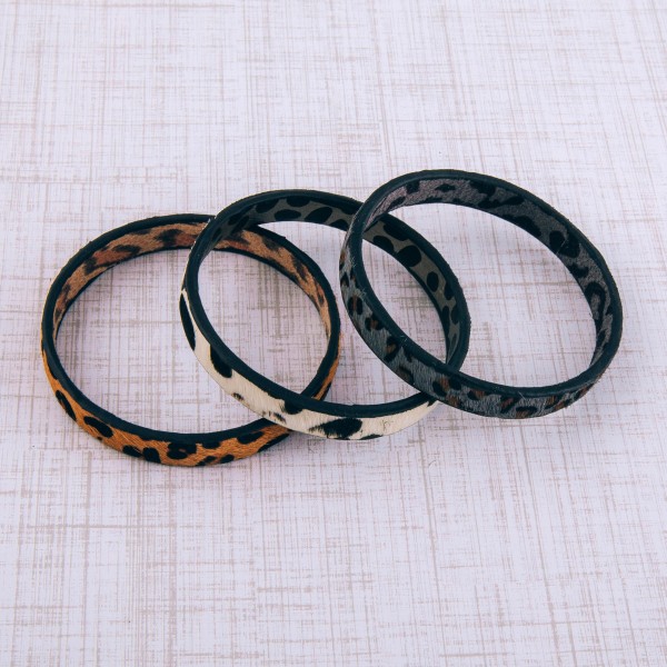 Genuine leather double sided leopard print cowhide bangle bracelet.

- Approximately 3" in diameter
- Fits up to a 6" wrist