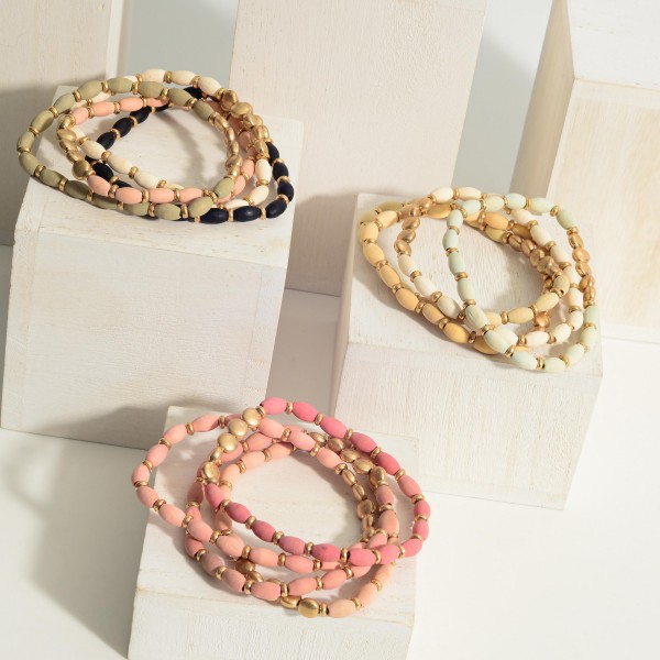 Set of Four Beaded Bracelets Featuring Gold Accents. 

- Approximately 3" in Diameter 