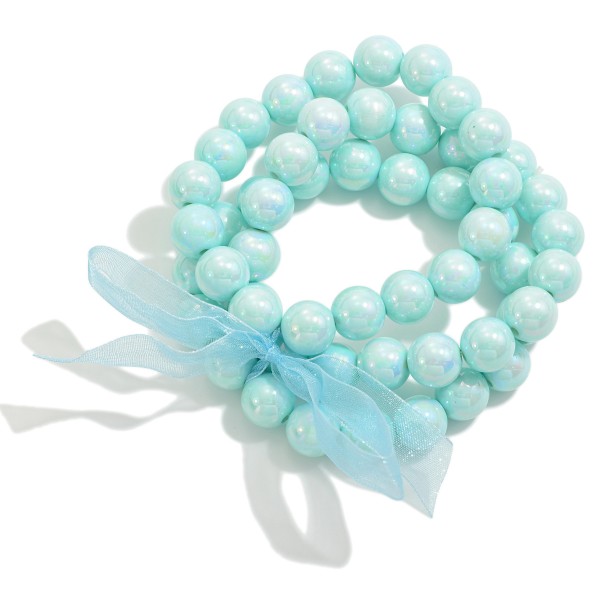 Set of Three Pearlescent Beaded Stretch Bracelets With Tied Bow Detail

- Approximately 2.5" D