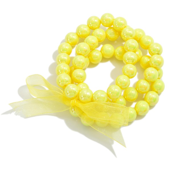 Set of Three Pearlescent Beaded Stretch Bracelets With Tied Bow Detail

- Approximately 2.5" D