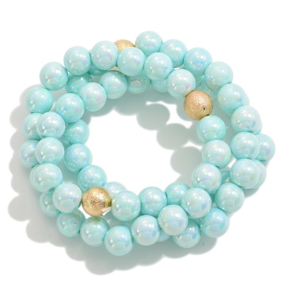 Set of Three Pearlescent Beaded Stretch Bracelets With Dimpled Gold Bead Accent

- Approximately 2.5" D