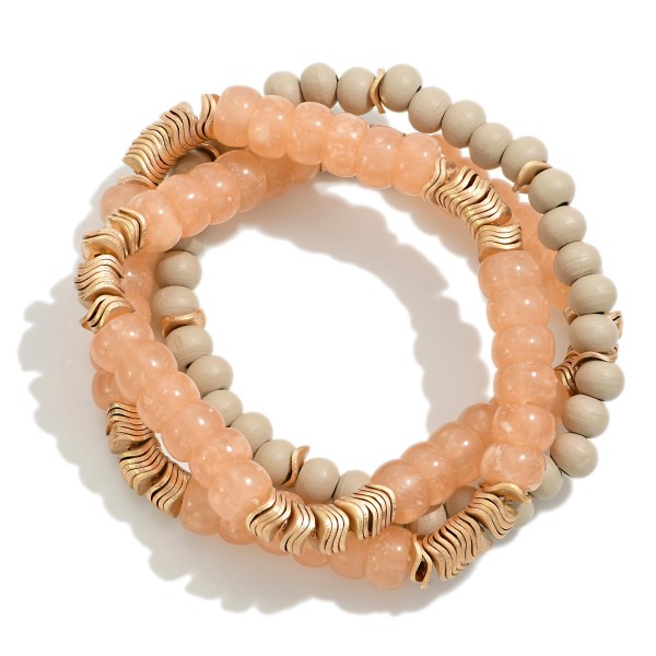 Set of Three Beaded Stretch Bracelets Featuring Wood, Acetate, and Wavy Gold Tone Disk Beads

- Approximately 2.5" D