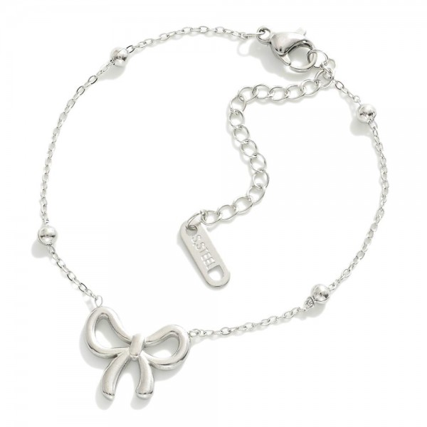 Metal Tone Saturn Chain Link Bracelet Featuring Bow Station

- Approximately 3." D
- Extender 2" L