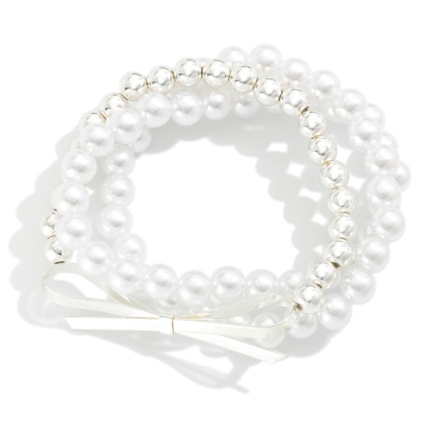 Set of Three Beaded Stretch Bracelets Featuring Pearl and Metal Tone Beads With Metal Bow Charm

- Approximately 2.5" D