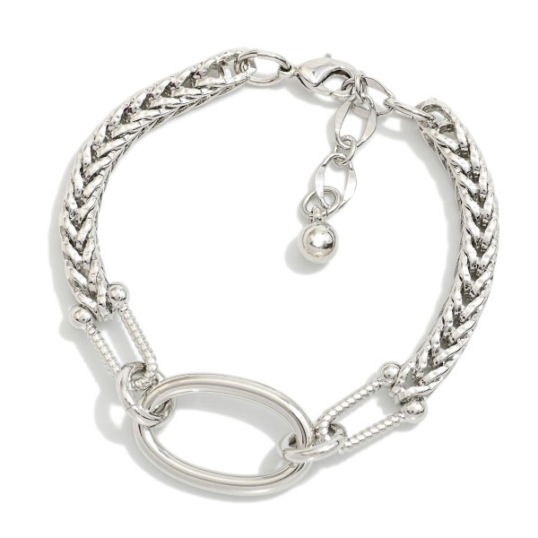 Metal Tone Bracelet With Braided Chain Design Featuring Oval Link and Textured Clasp 

- Gold Dipped
- Approximately 3" L
- Extender 1" L