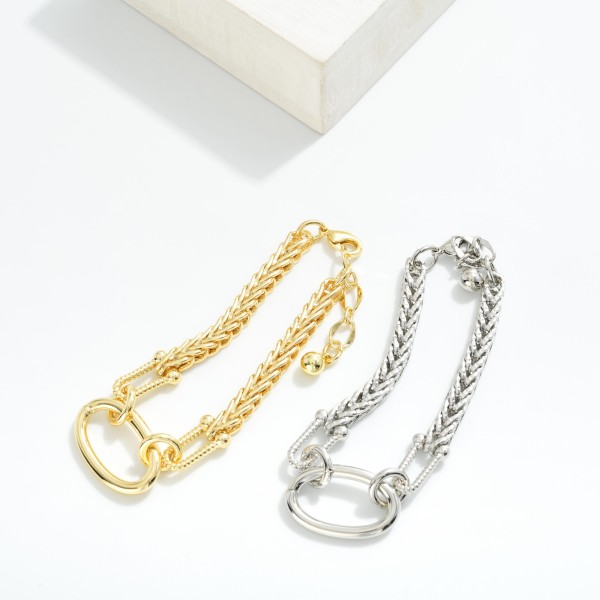 Metal Tone Bracelet With Braided Chain Design Featuring Oval Link and Textured Clasp 

- Gold Dipped
- Approximately 3" L
- Extender 1" L