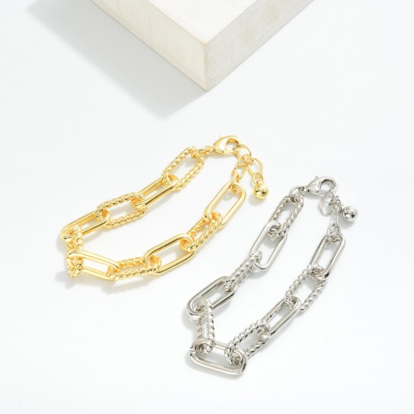 Paperclip Chain Link Bracelet Featuring Twisted Metal Links

- Gold Dipped
- Approximately 3" D
- Extender 1" L