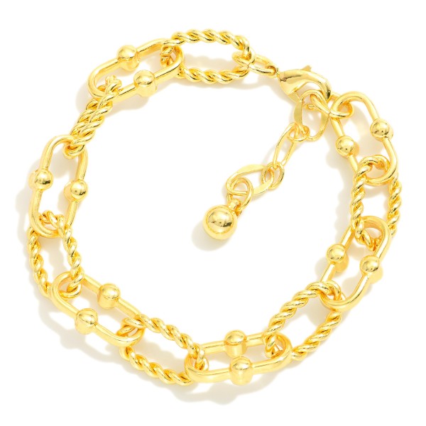 Chain Link Bracelet Featuring Twisted Metal Links

- Gold Dipped
- Approximately 3" L
- Extender 1" L