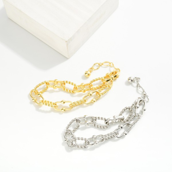 Chain Link Bracelet Featuring Twisted Metal Links

- Gold Dipped
- Approximately 3" L
- Extender 1" L