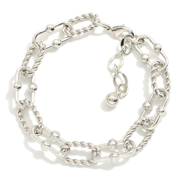 Chain Link Bracelet Featuring Twisted Metal Links

- Gold Dipped
- Approximately 3" L
- Extender 1" L