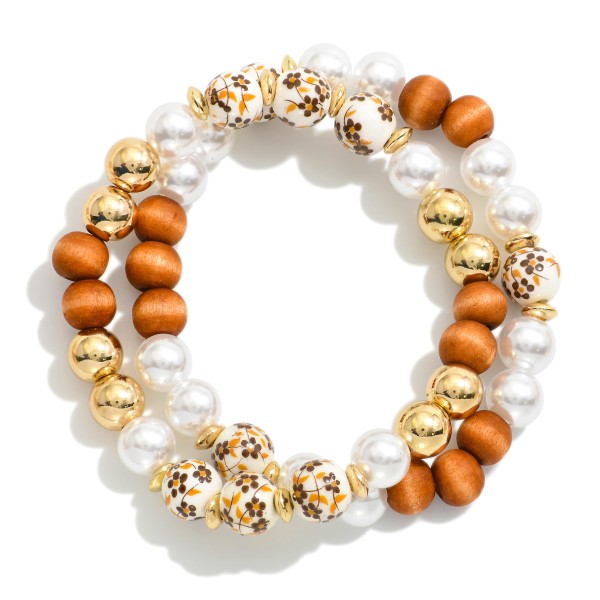 Set Of Two Beaded Stretch Bracelets Featuring Wood, Pearl, & Floral Porcelain Beads

- Approximately 2.5" D 
