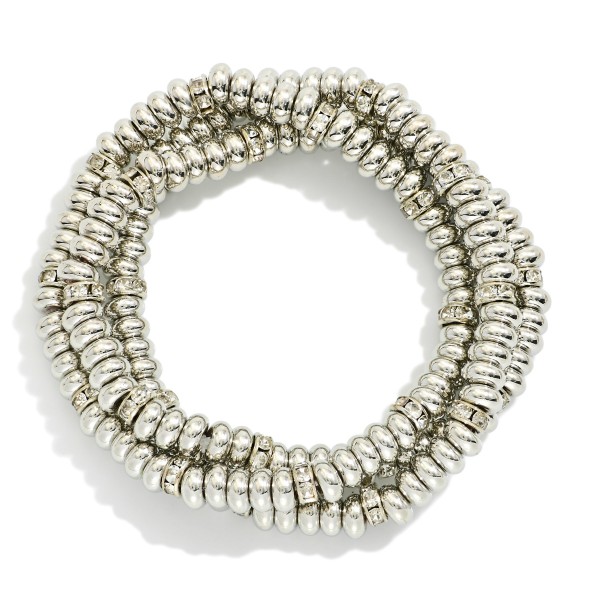 Set Of Three Metal Tone Disk Bead Stretch Bracelets Featuring Rhinestone Details 

- Approximately 2.5" D 

