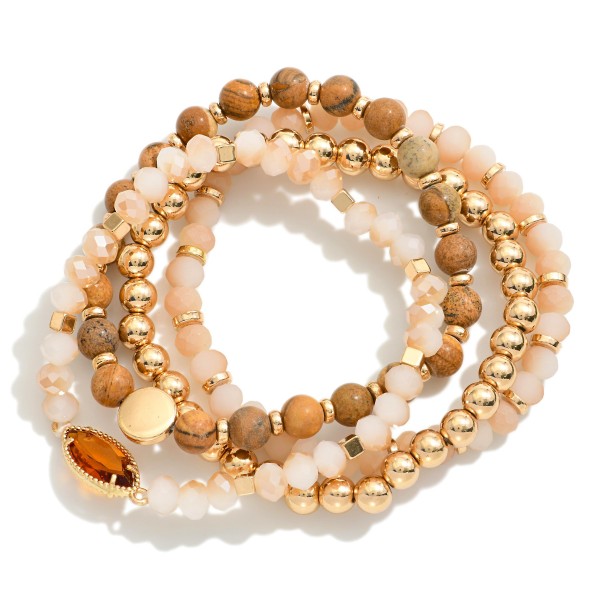 Set Of Four Beaded Stretch Bracelets Featuring Stone Beads & Gold Tones 

- Approximately 3" D 