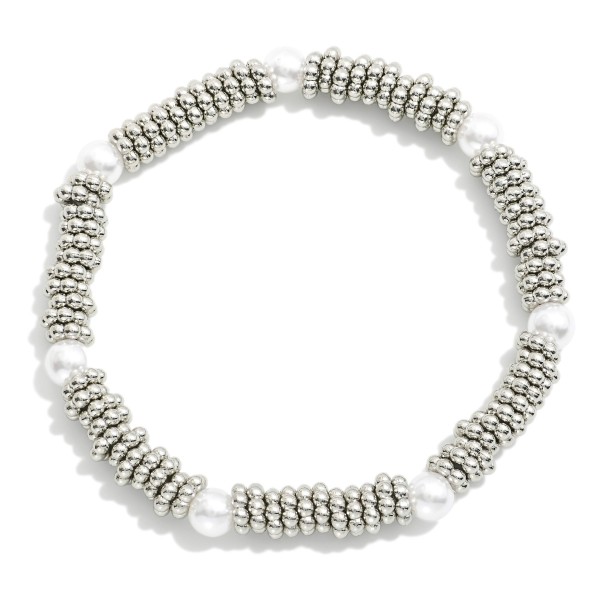 Metal Tone Ridded Disc Stretch Bracelet Featuring Peal Stations

- Approximately 2.5" D  
