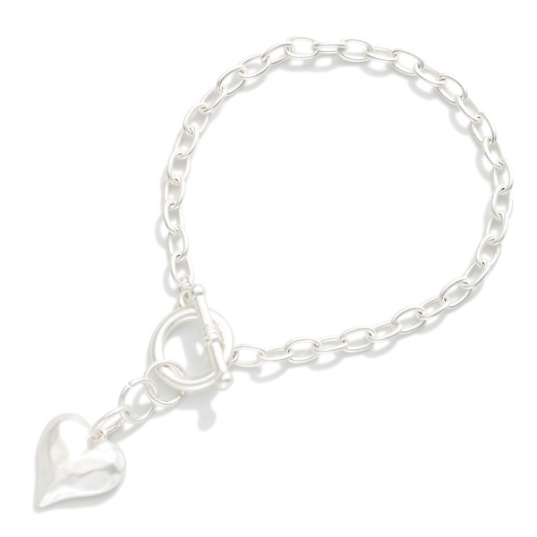 Chain Link Toggle Clasp Bracelet Featuring Hammered Metal Heart Pendant 

- Approximately 2.5" D