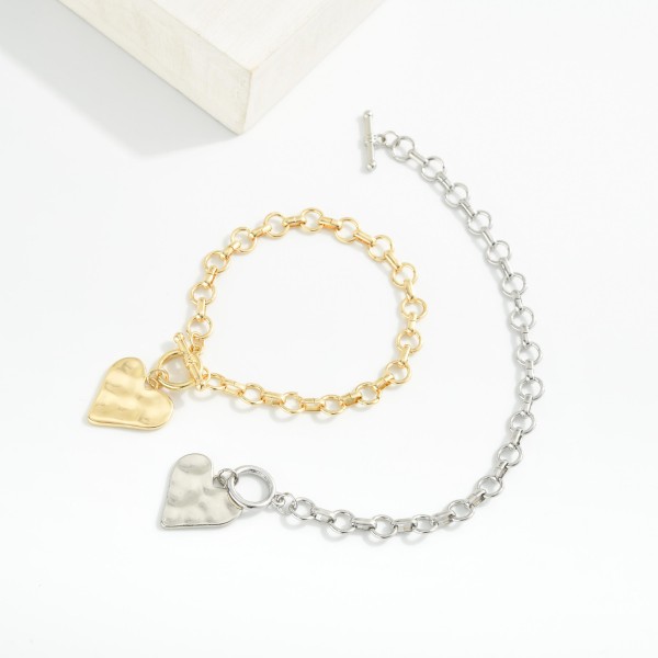 Metal Tone Chain Link Bracelet Featuring Toggle Clasp & Heart Charm 

- Approximately 4" D 