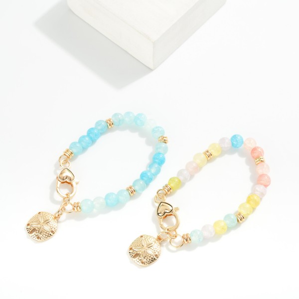Cracked Bead Beaded Bracelet Featuring Metal Tone Sand Dollar Charm 

- Approximately 3" D
