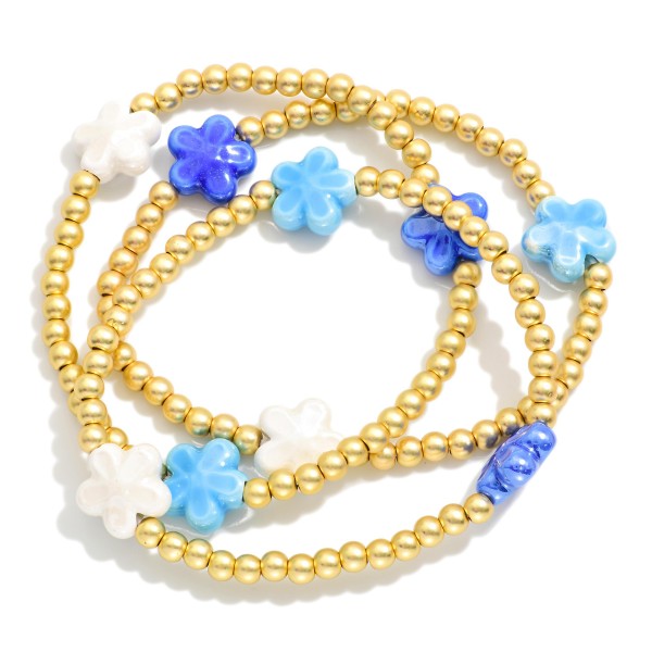 Set Of Three Metal Tone Beaded Stretch Bracelets Featuring Porcelain Flower Stations 

- Approximately 2.5" D
