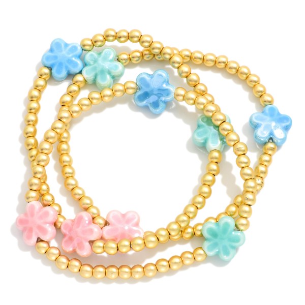 Set Of Three Metal Tone Beaded Stretch Bracelets Featuring Porcelain Flower Stations 

- Approximately 2.5" D