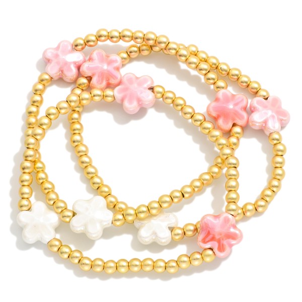 Set Of Three Metal Tone Beaded Stretch Bracelets Featuring Porcelain Flower Stations 

- Approximately 2.5" D