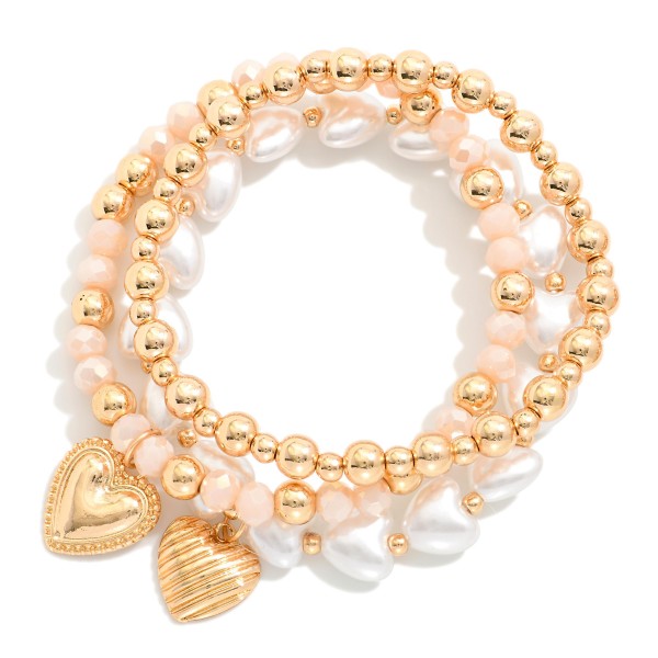 Set Of Three Beaded Stretch Bracelets Featuring Metal Tones, Faceted Beads, & Hearts 

- Approximately 3.75" D 