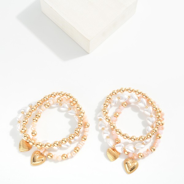Set Of Three Beaded Stretch Bracelets Featuring Metal Tones, Faceted Beads, & Hearts 

- Approximately 3.75" D 