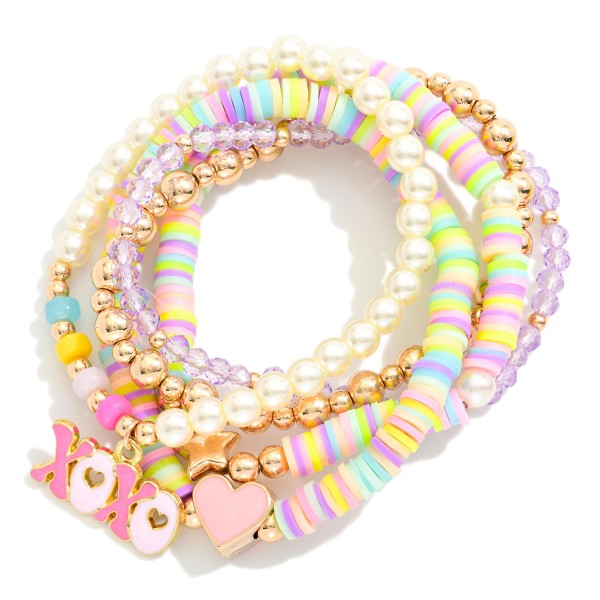 Set Of Five Beaded Stretch Bracelets Featuring Metal Tones, Faceted Beads , & "XOXO'' Charm 

- Approximately 3.75" D 